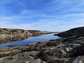 Scenic view of lake and mountains against sky