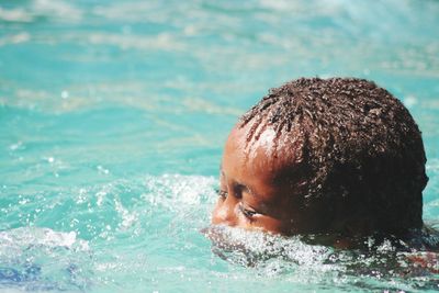 Close-up of boy swimming in pool