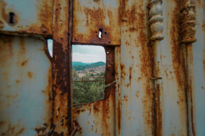 Rusty metal window of old abandoned building