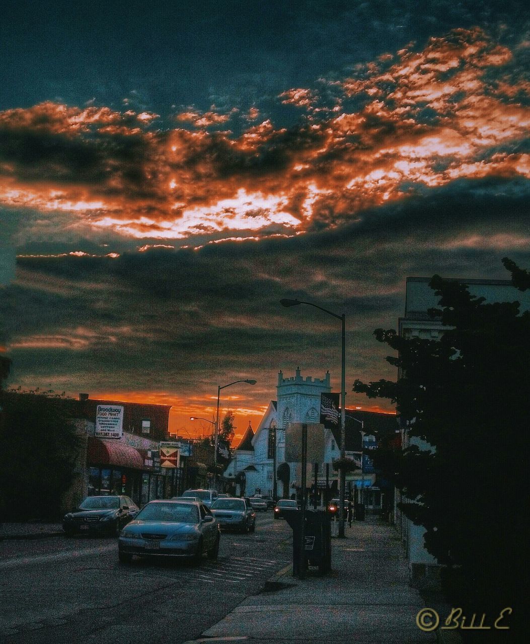 building exterior, architecture, built structure, city, transportation, car, land vehicle, mode of transport, sky, street, sunset, road, high angle view, cloud - sky, residential building, city life, residential structure, cityscape, outdoors, building