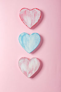 Directly above shot of heart shape over pink background