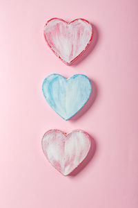 Directly above shot of heart shape over pink background