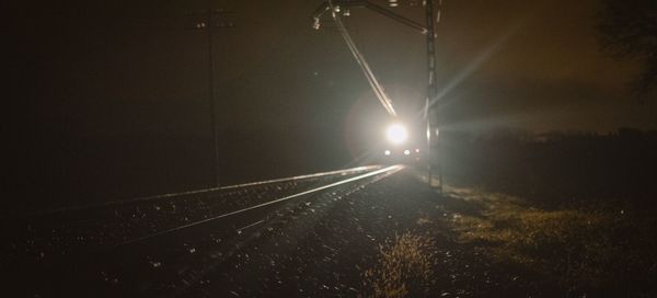 View of illuminated road at night