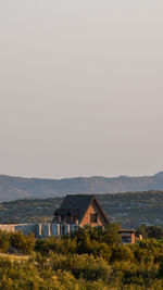 House on field against clear sky