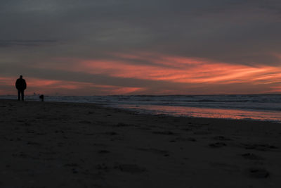 Scenic view of beach against sky during sunset