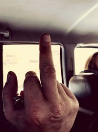 Close-up of hand holding camera in car