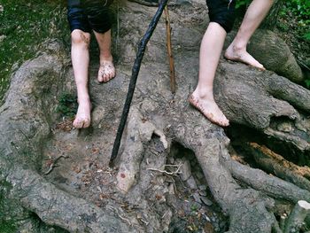 Low section of man standing on rock