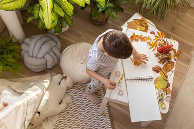 High angle view of woman holding pumpkin