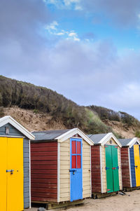 Houses on mountain against blue sky