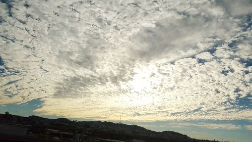 Scenic view of mountains against cloudy sky