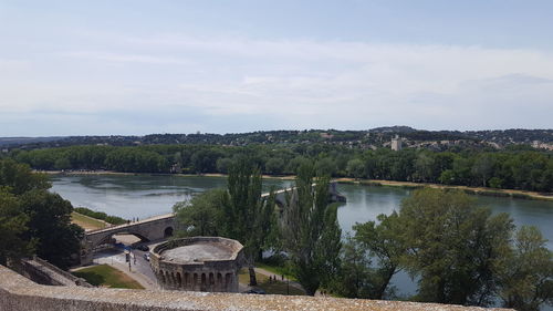 Scenic view of lake by trees against sky