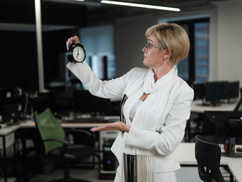 Side view of young woman using mobile phone