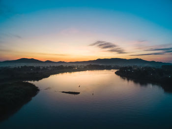 Scenic view of lake against sky during sunset