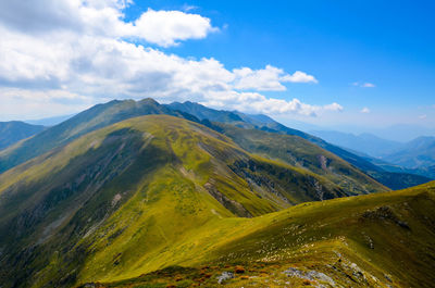 Scenic view of mountains against cloudy sky