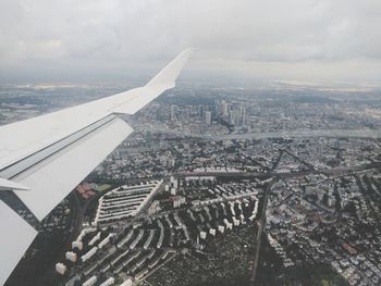 High angle view of cityscape against cloudy sky