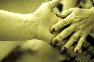 Close-up of women holding hands