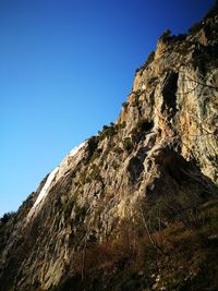 Low angle view of mountain against clear blue sky