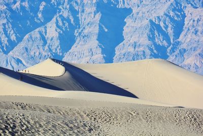 View of desert against rocky mountains