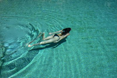 High angle view of woman swimming in pool