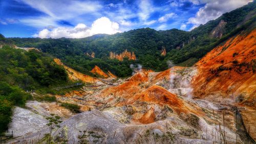 Scenic view of mountains against cloudy sky