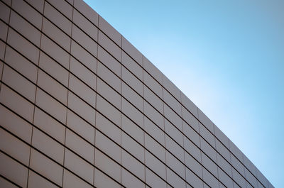 Low angle view of modern building against clear blue sky