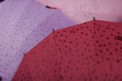 Low angle view of pink umbrella against sky