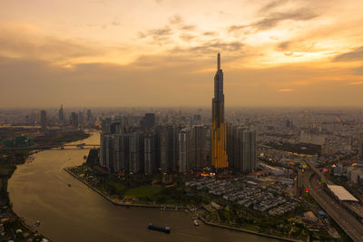 High angle view of buildings in city during sunset