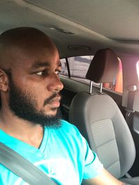 Portrait of man sitting in car