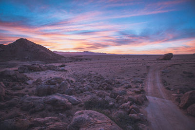 Scenic view of desert against sky during sunset