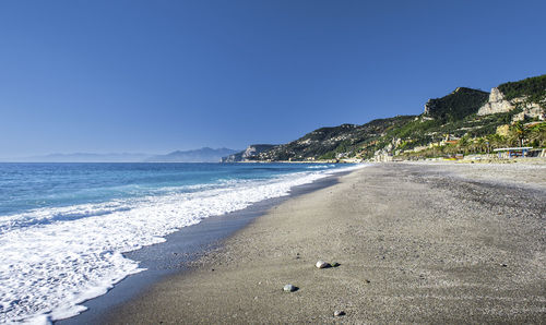 Scenic view of sea against clear blue sky