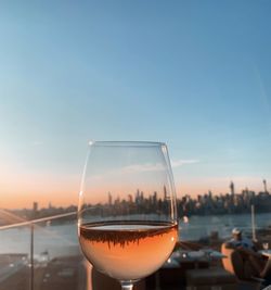 Close-up of beer in water against sky during sunset