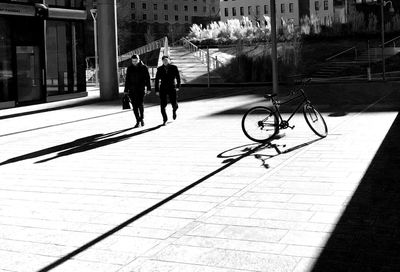 People on footpath in city