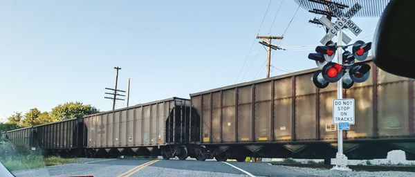 Train on railroad track against clear sky