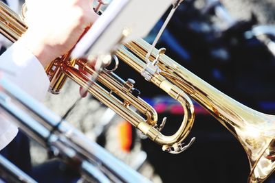 Cropped hand playing trumpet at event