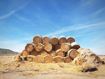 Stack of rocks on field against sky