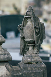 Close-up of buddha statue in cemetery