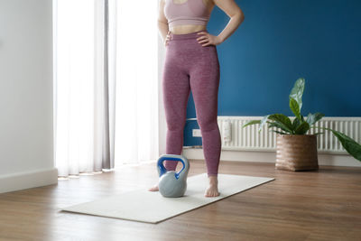 Low section of woman exercising at home