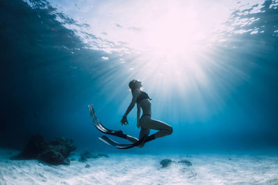 Low angle view of man swimming in sea