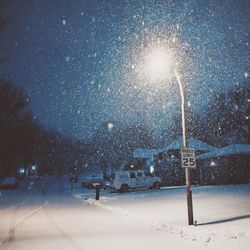 Scenic view of snow covered landscape against sky at night