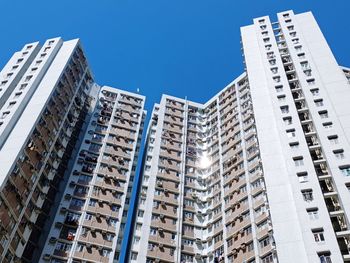 Low angle view of modern buildings against clear blue sky