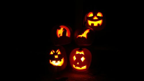 View of lit candle in dark room