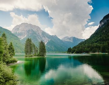 Scenic view of lake by mountains against sky