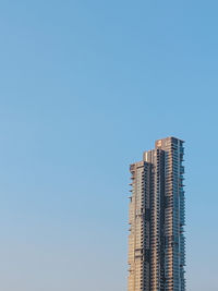 Low angle view of modern building against clear blue sky