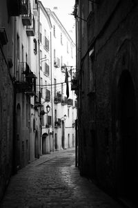 Narrow alley amidst buildings in city