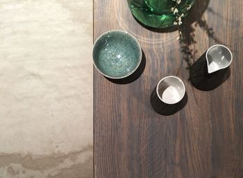 Directly above shot of pitcher and bowls on wooden table