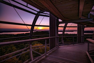 Bridge over sea against sky during sunset