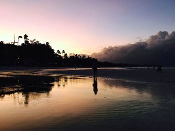 Scenic view of lake at sunset