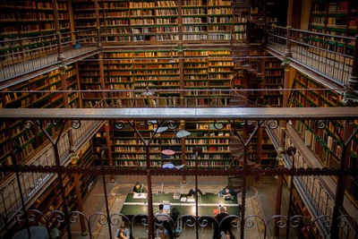 High angle view of people reading books in rijksmuseum research library