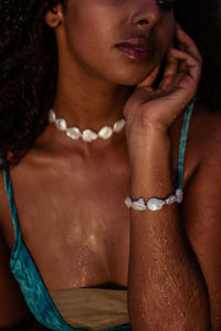 Portrait of shirtless young woman in pearly 