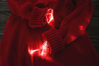 High angle view of illuminated string light in sweater